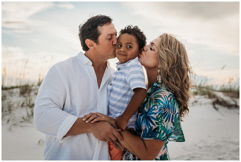 Pensacola Beach Family Photography Session Family Embracing near sand dunes. Pensacola Family Photographer