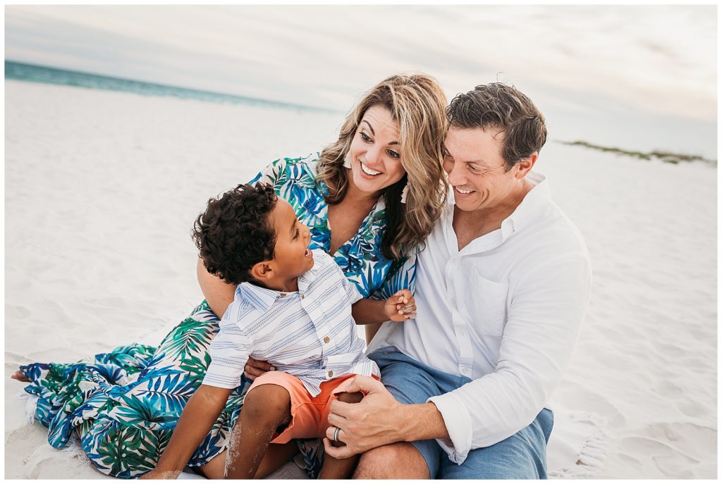 Pensacola Beach Family Photography Session Family sitting on beach interacting with joyful faces. Pensacola Photographer