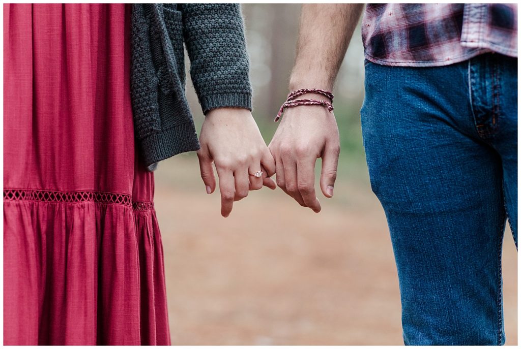 Engagement Photoshoot Locations in Pensacola with newly engaged couple holding pinkies