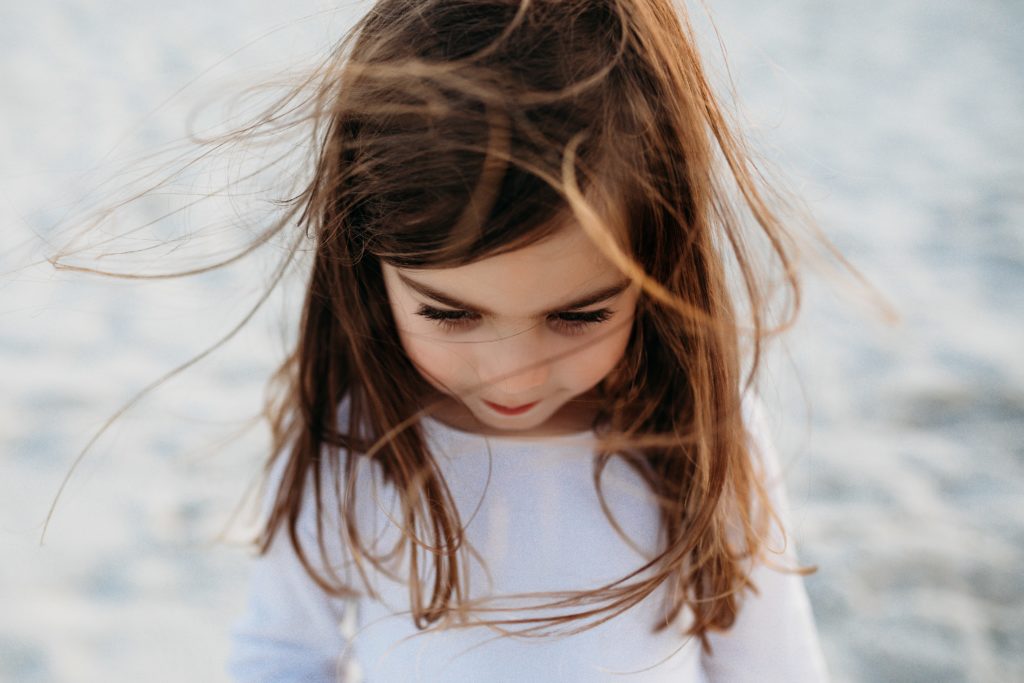 Young girl with hair blowing all around 