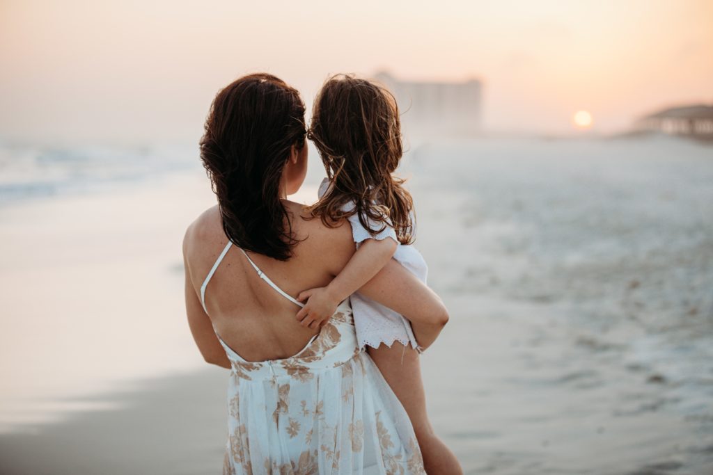 Mom talking sweetly to daughter about the sunset 