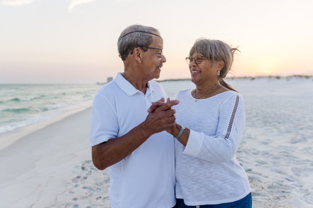 Couple dancing on beach during family photo session