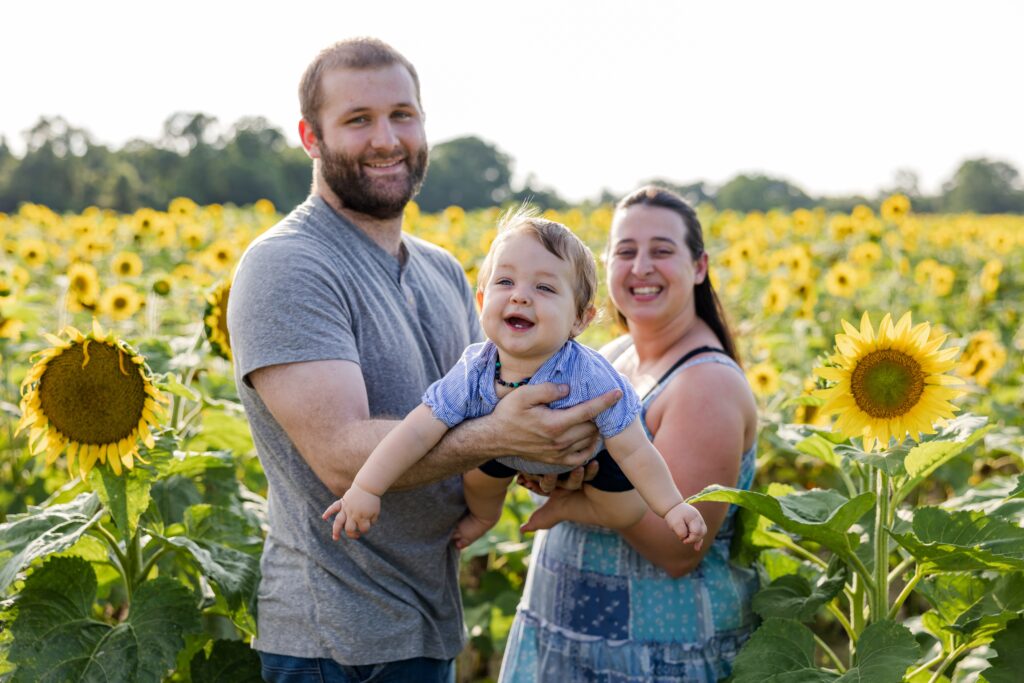 Fun fall family photo session by Jennifer Beal Photography in Holland Farms sunflower field.