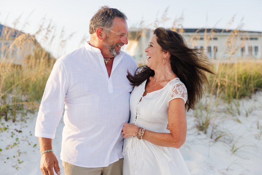 Couple laughing during Navarre Beach photo session by Jennifer Beal Photography
