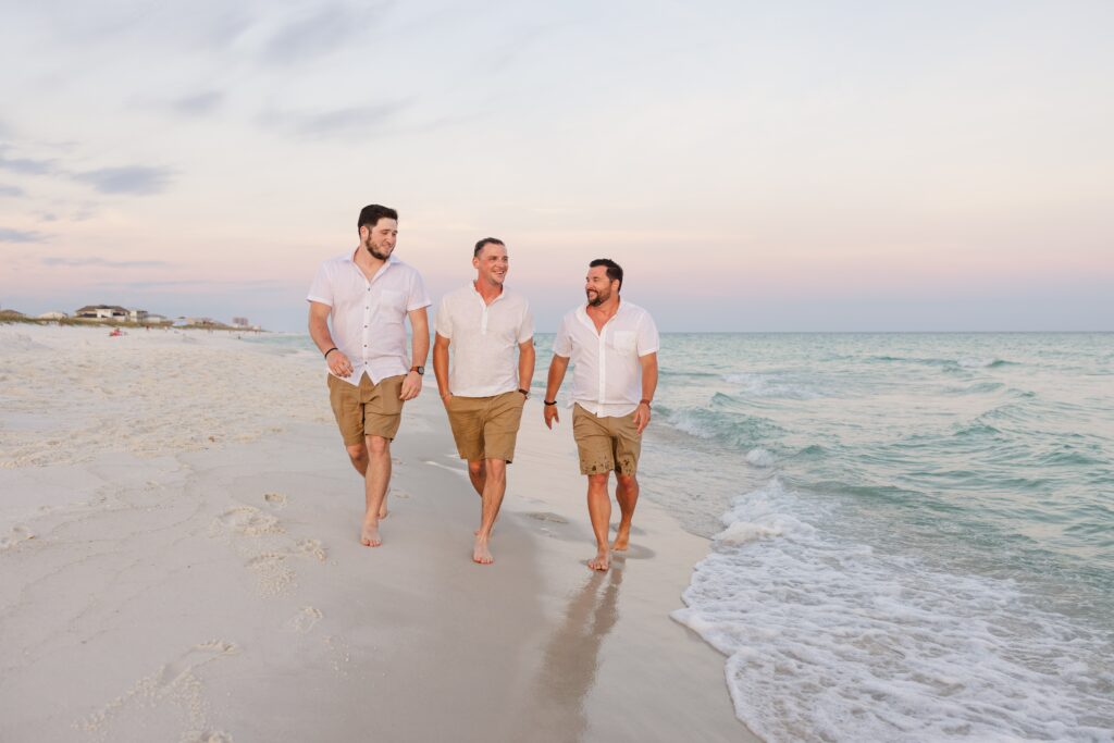 Brothers walking down beach during Navarre Beach photography session