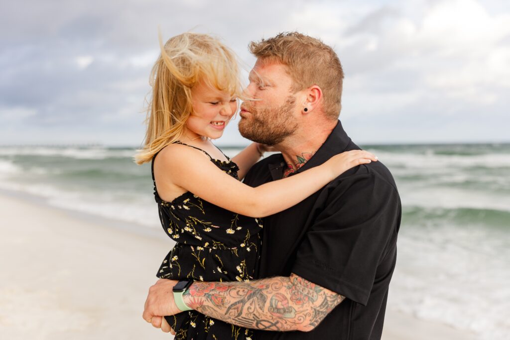 Family photo of daddy and daughter playing on Pensacola Beach