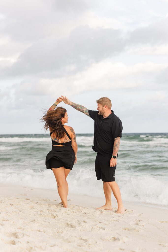Couple dancing on Pensacola Beach during photo session.