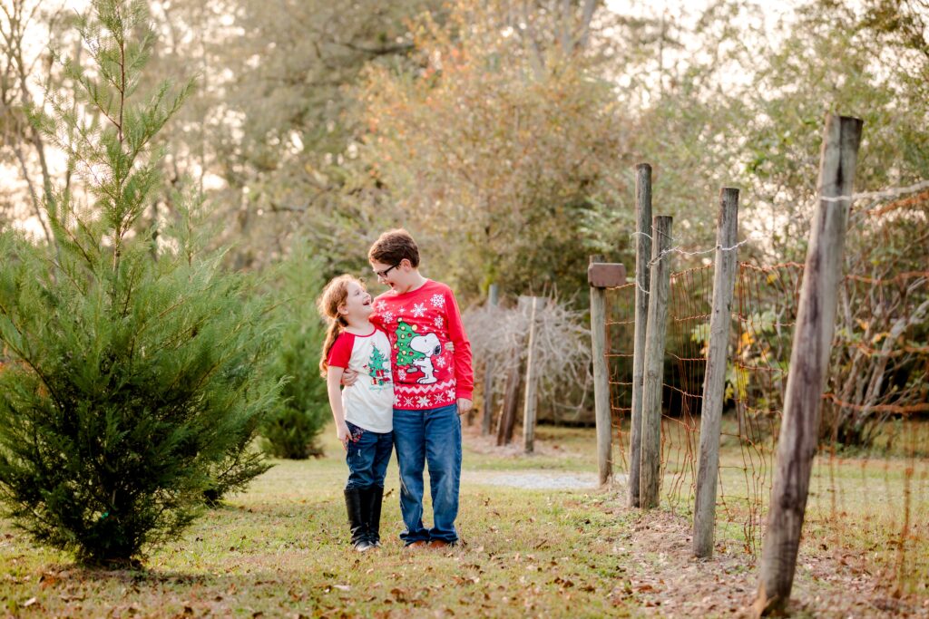 Brother and sister Christmas family picture taken during holiday mini-session by Pensacola Photography, Jennifer Beal.