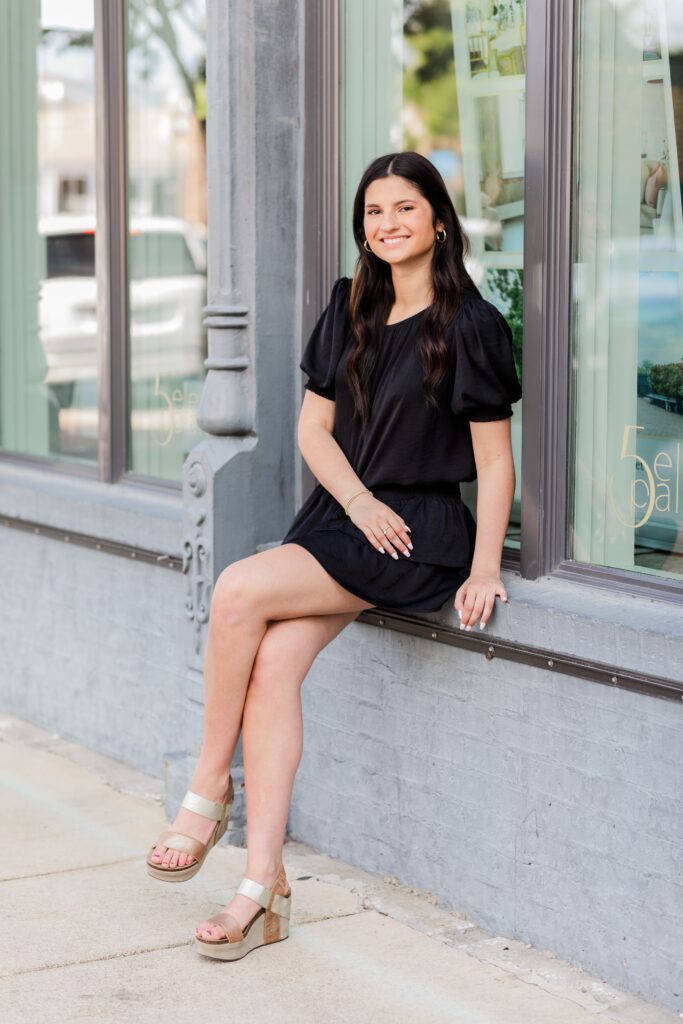 High School Senior Girl Photo Session  with girl sitting in storefront window