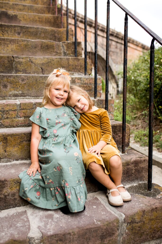 Little girls sitting on the steps at Fort Pickens