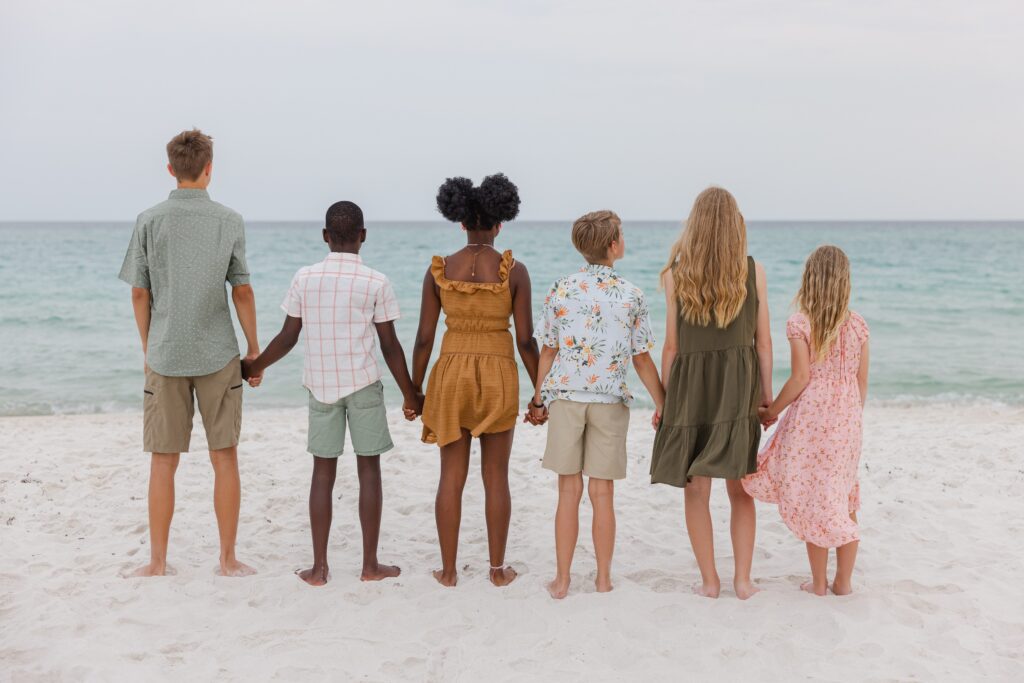 Six siblings are watching the water during photo session