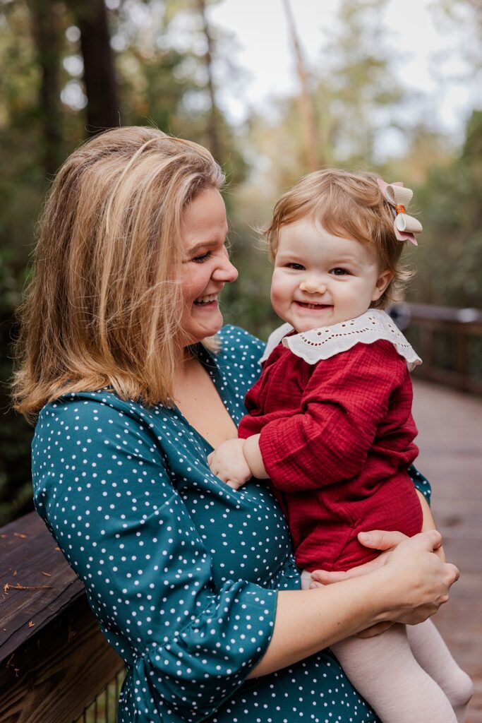 Mother and young daughter pose during family photos by Pensacola Photographer, Jennifer Beal