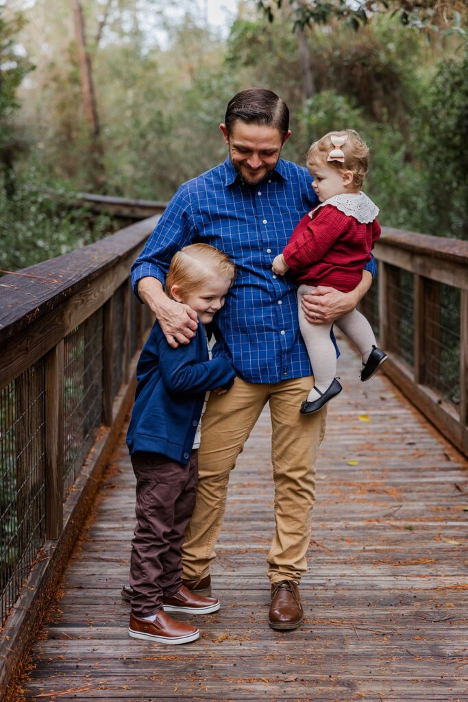 Father with 2 kids pose during annual family photos by Pensacola Photographer, Jennifer Beal