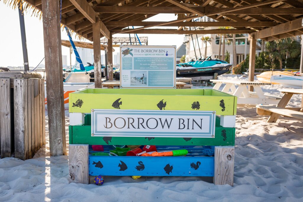 Borrow bin at Quietwater Beach Boardwalk for children to share beach toys.