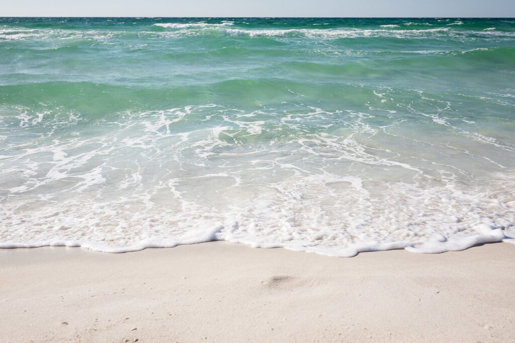 Waves washing up on the white sands of Pensacola Beach
